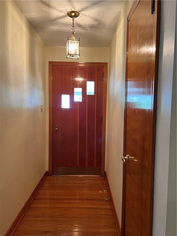 Entry with gleaming hardwood flooring.