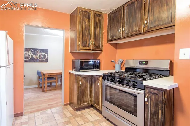 a kitchen with a sink and a refrigerator