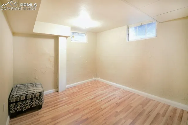 a view of an empty room with wooden floor