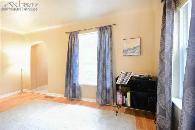 a dining room with a table and windows