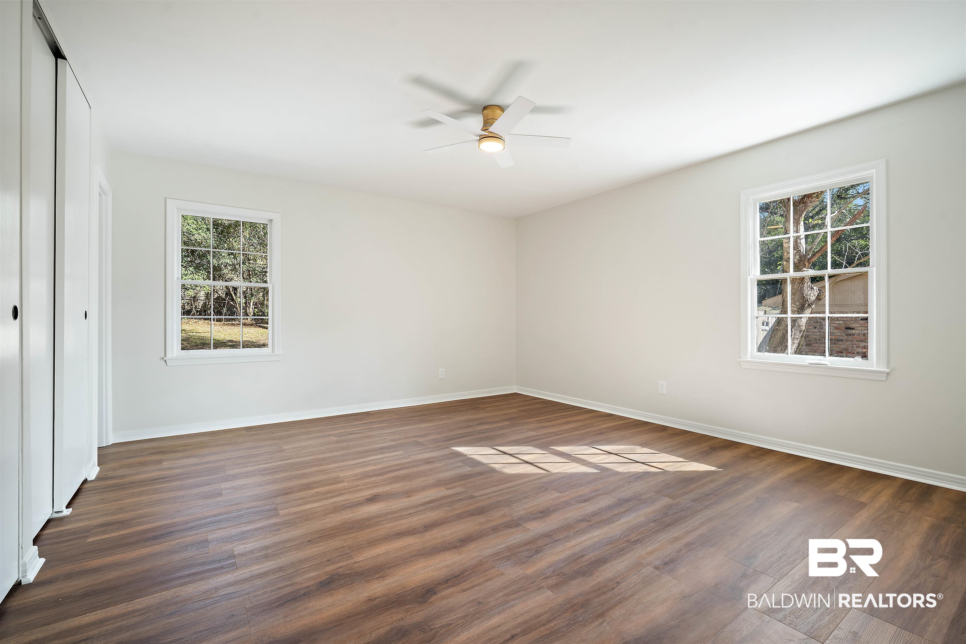 860 Montfort Road South Mobile, AL 36608 - Photo 15 of 27 Unfurnished bedroom with dark wood-style flooring, a closet, and a ceiling fan