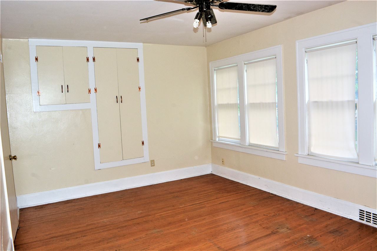 1806 Ridge Avenue Rockford, IL 61103 - Photo 11 of 18 an empty room with wooden floor cabinet and windows