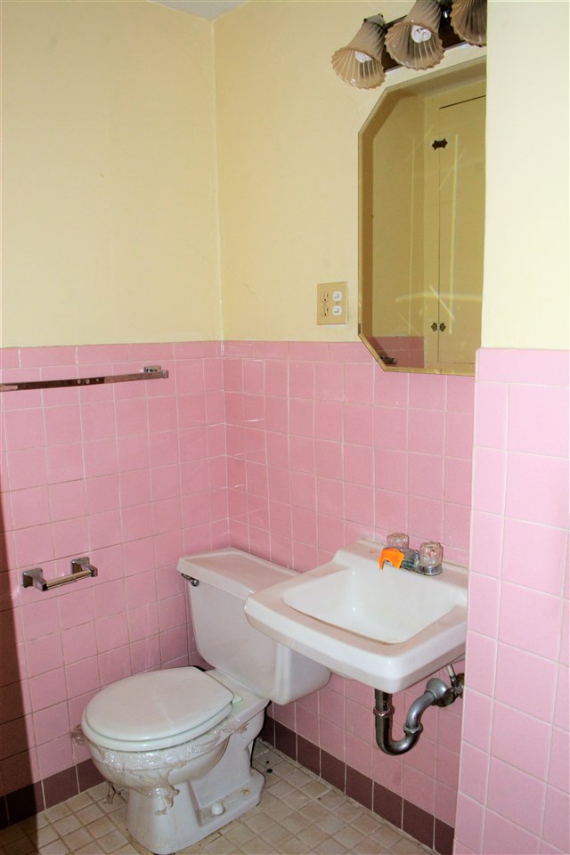1806 Ridge Avenue Rockford, IL 61103 - Photo 12 of 18 a bathroom with a sink a toilet and a mirror