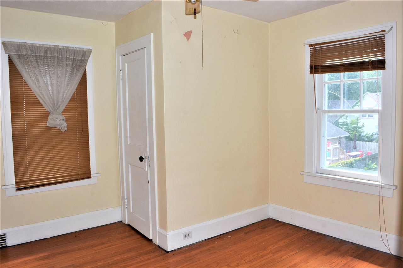 1806 Ridge Avenue Rockford, IL 61103 - Photo 14 of 18 a view of an empty room with wooden floor and a window