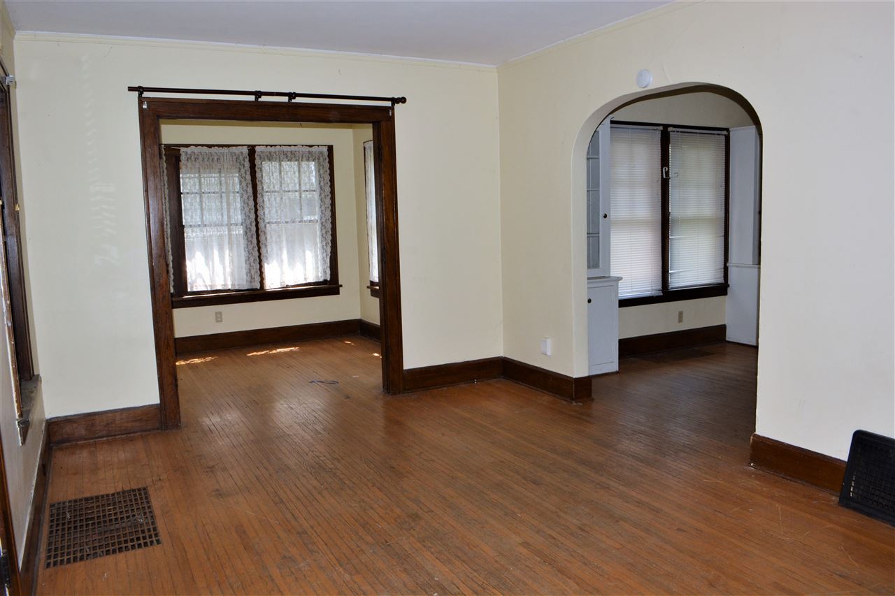 1806 Ridge Avenue Rockford, IL 61103 - Photo 3 of 18 a view of an empty room with wooden floor and a window