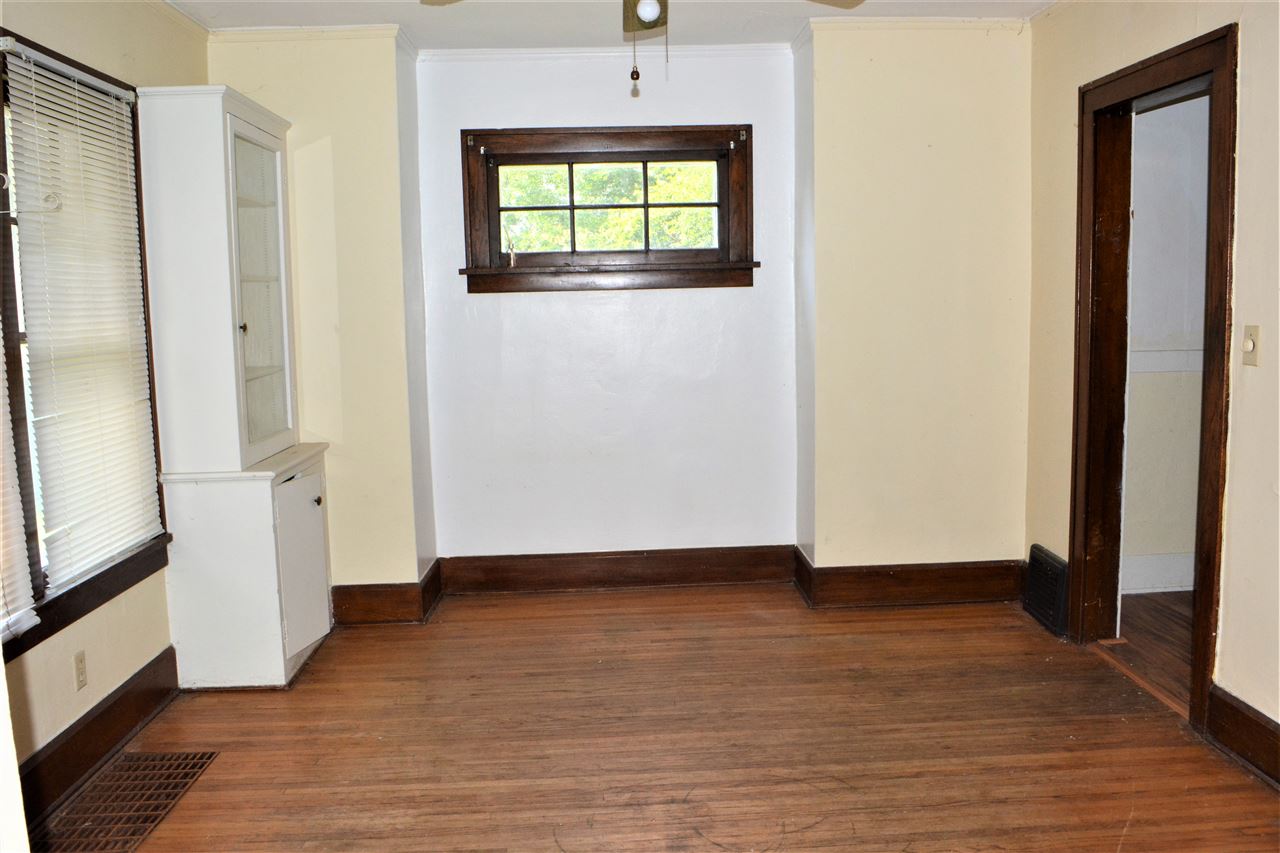1806 Ridge Avenue Rockford, IL 61103 - Photo 7 of 18 a view of an empty room with wooden floor and a window