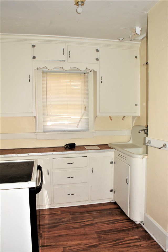 1806 Ridge Avenue Rockford, IL 61103 - Photo 9 of 18 a view of a kitchen counter space a sink wooden floor and a window
