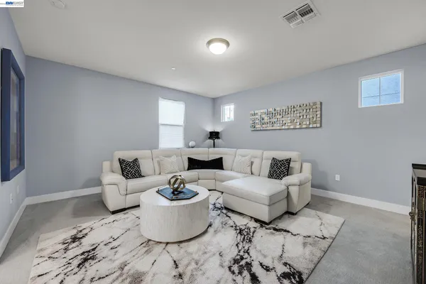 a bedroom with a bed and a painting on the wall