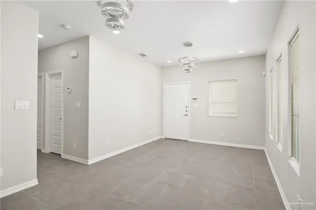 wooden floor in an empty room with a bathroom