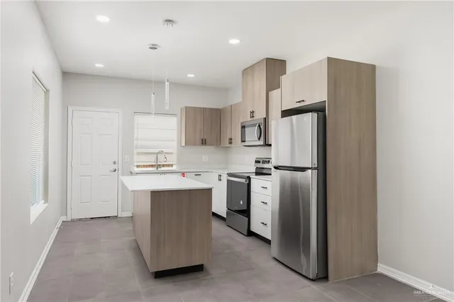 a kitchen with cabinets and stainless steel appliances