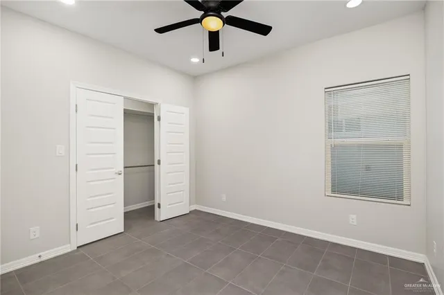 a view of an empty room with a ceiling fan