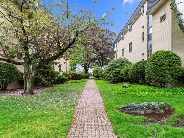 a view of a pathway with a house in the background