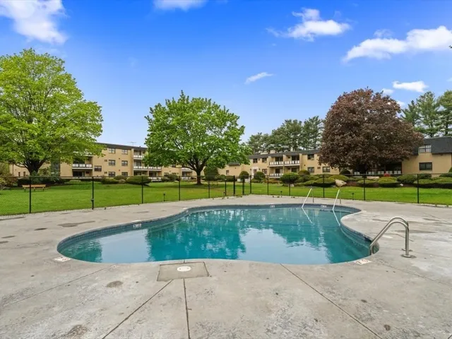 a view of a swimming pool and a yard