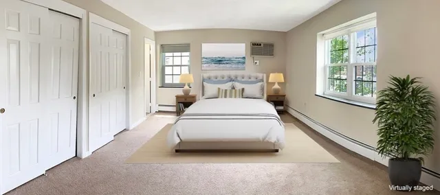 a view of a bedroom with a bed and a potted plant