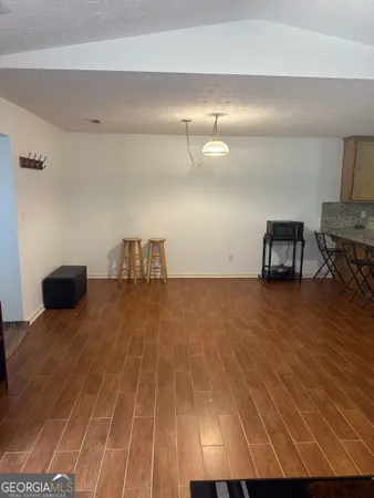 a room with wooden floor and furniture