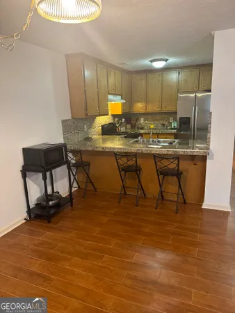 a room with table chairs and wooden floor