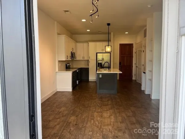a view of a kitchen with a sink and cabinets