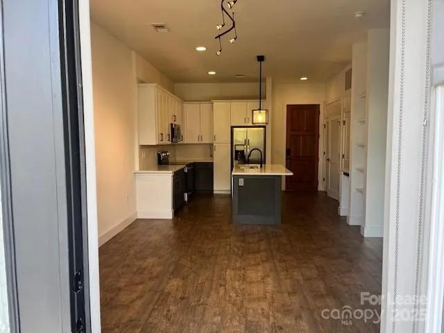 a view of a kitchen with a sink and cabinets