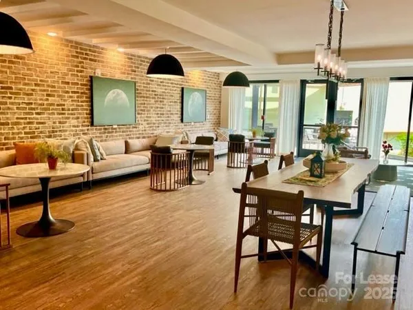 a living room with fireplace furniture and a large window