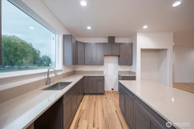 a kitchen with sink cabinets and wooden floor
