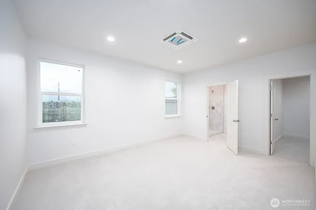 an empty room with windows and closet