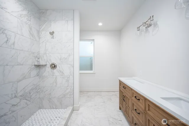 a bathroom with a bathtub and shower