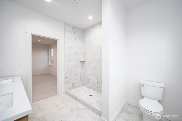 a bathroom with a toilet a sink and shower