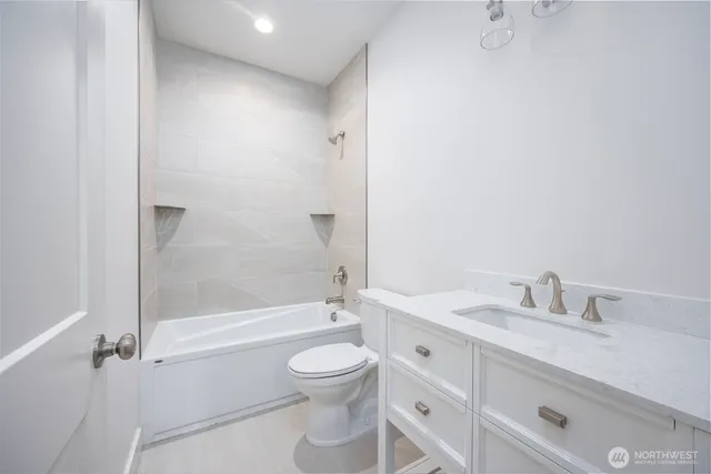 a bathroom with a toilet and a bathtub