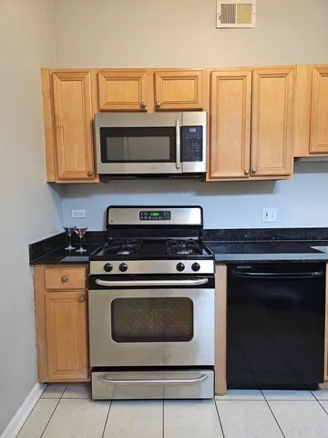 a kitchen with wooden cabinets and a stove top oven