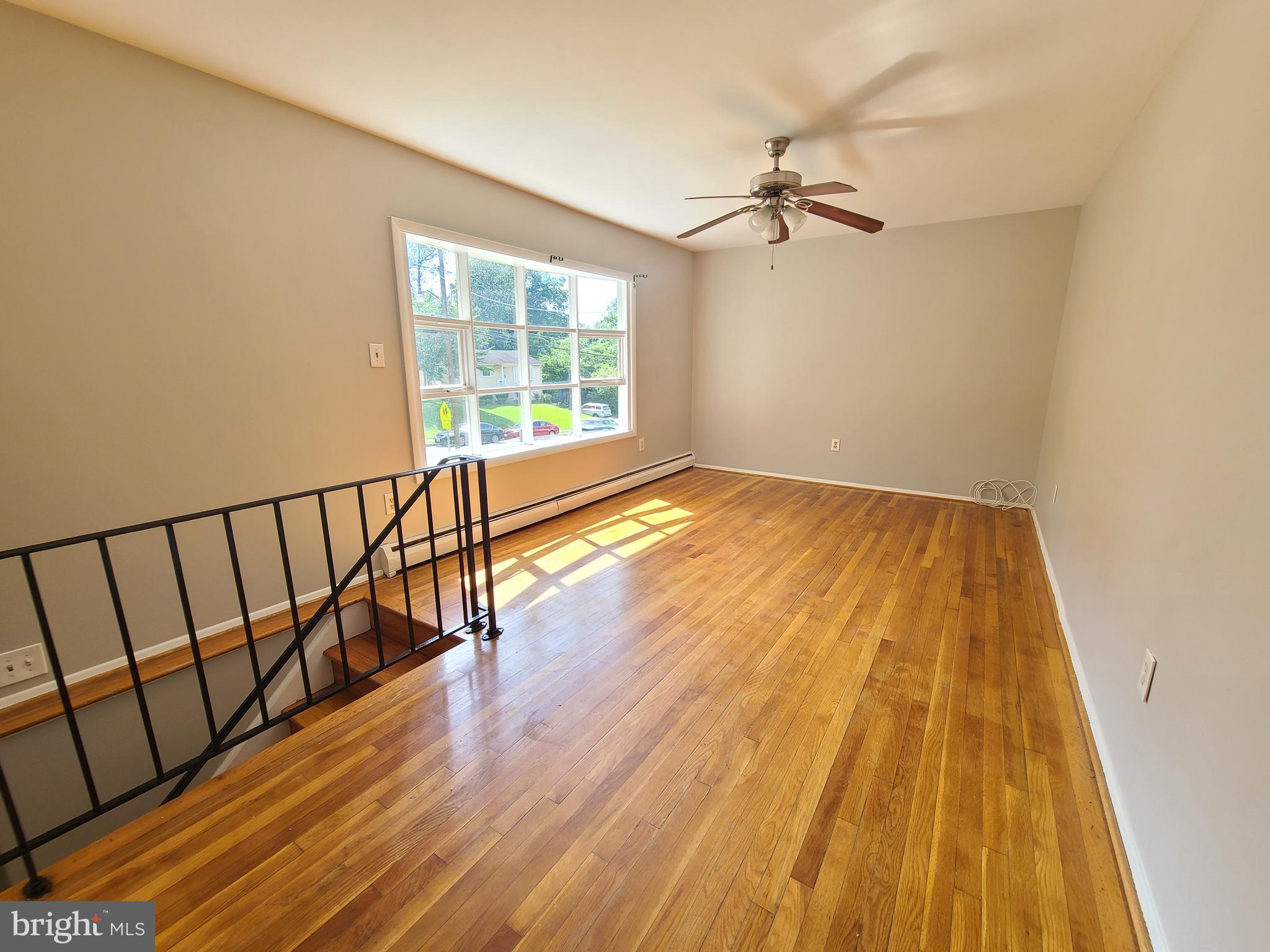 1524 Florida Avenue Woodbridge, VA 22191 - Photo 11 of 36 a view of a room with wooden floor staircase and a ceiling fan