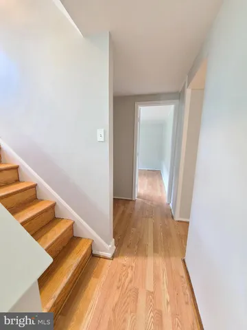 a view of a room with wooden floor