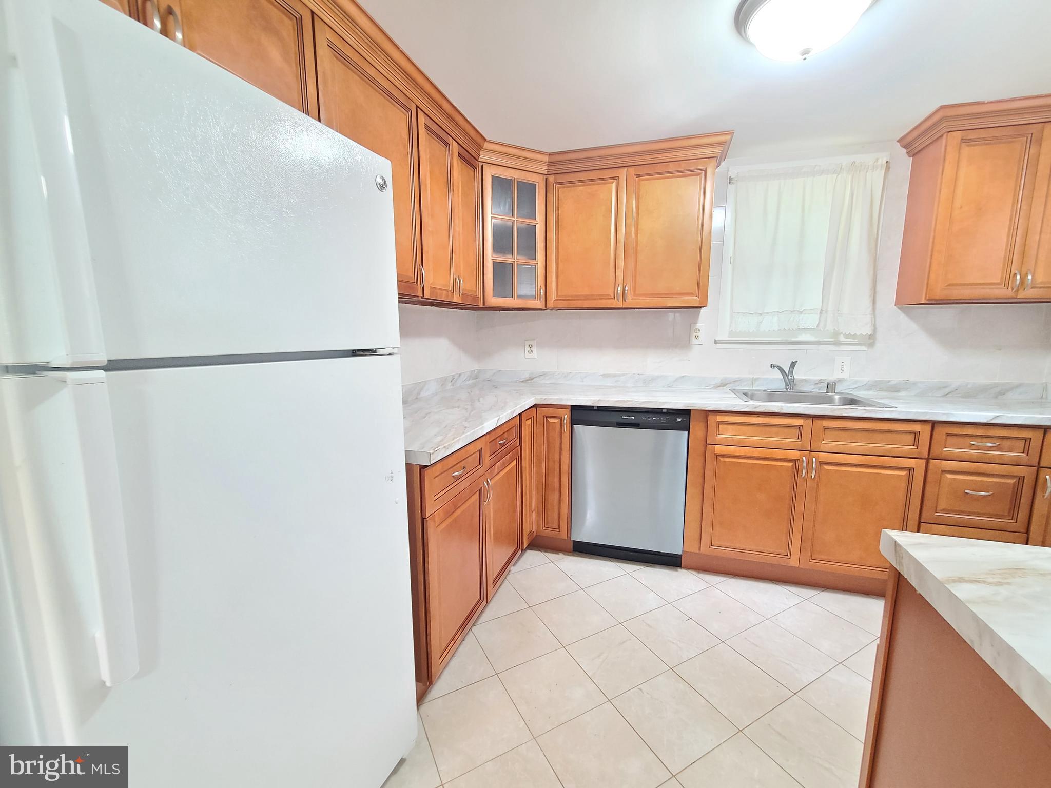 1524 Florida Avenue Woodbridge, VA 22191 - Photo 27 of 36 a kitchen with a refrigerator sink and cabinets