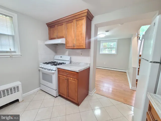 a kitchen with granite countertop a sink a stove and cabinets