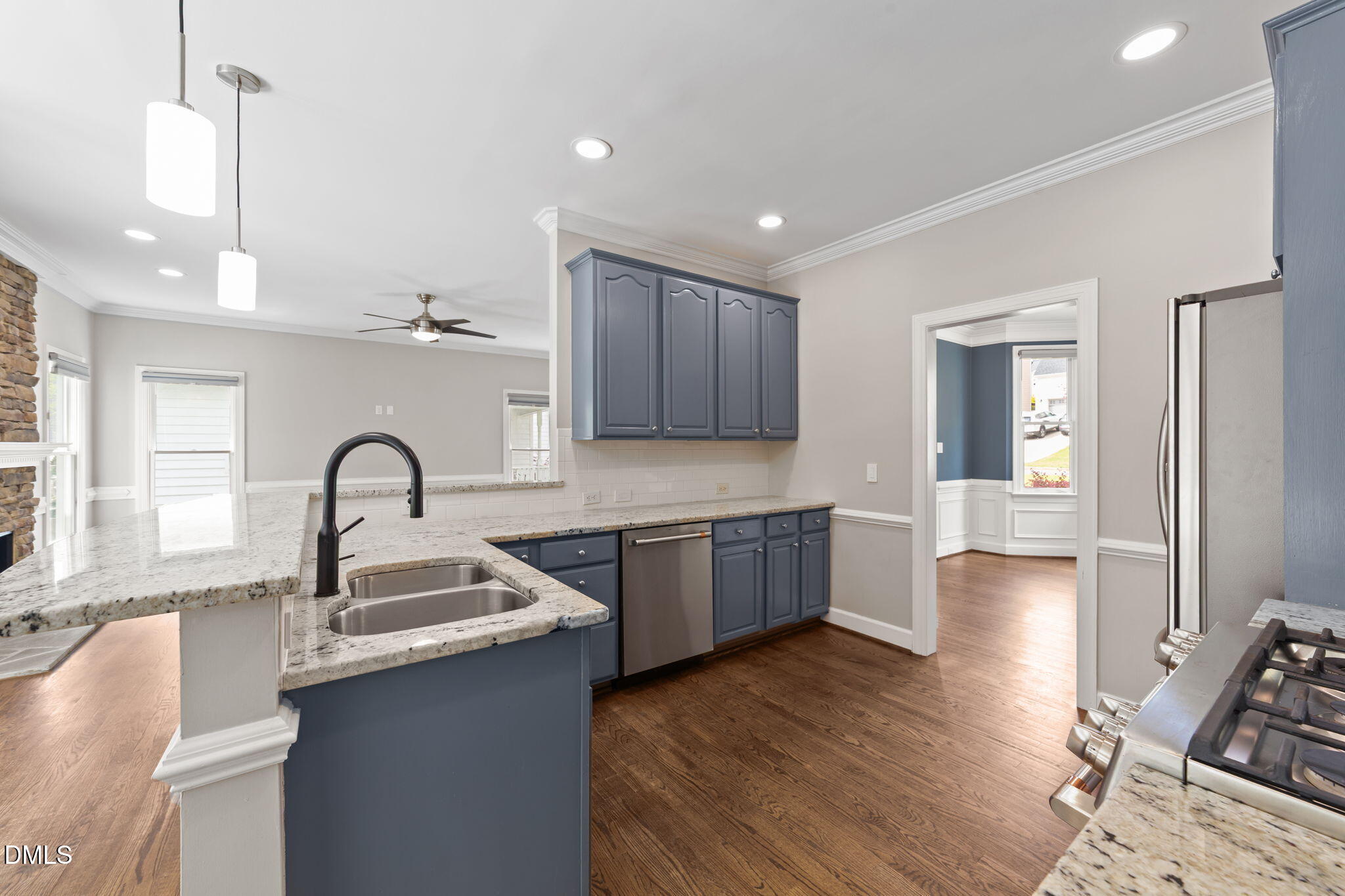 2004 Sassacus Lane Apex, NC 27523 - Photo 12 of 37 a kitchen with kitchen island granite countertop a sink cabinets and wooden floor