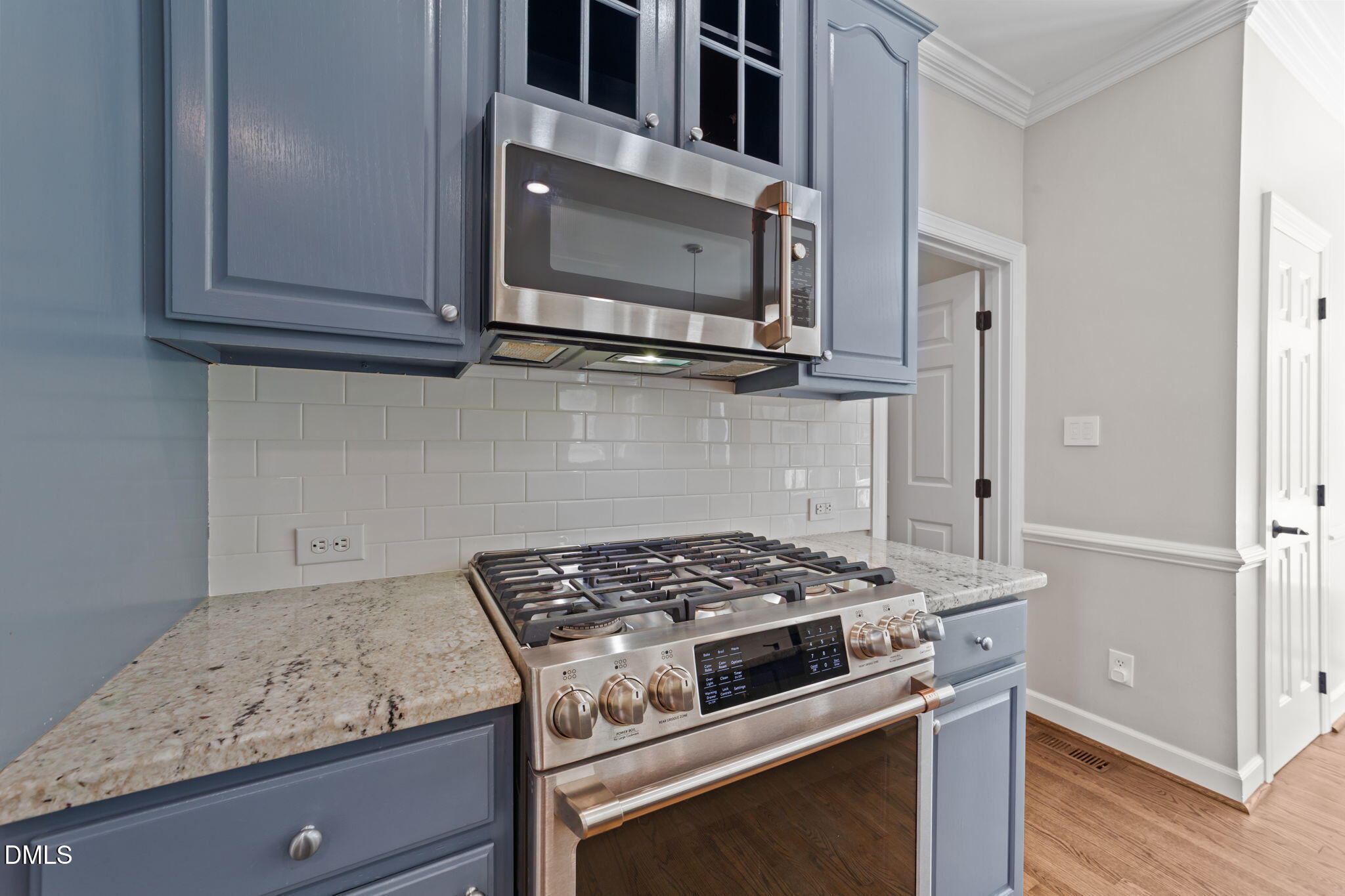 2004 Sassacus Lane Apex, NC 27523 - Photo 14 of 37 a kitchen with granite countertop cabinets stainless steel appliances and wooden floor