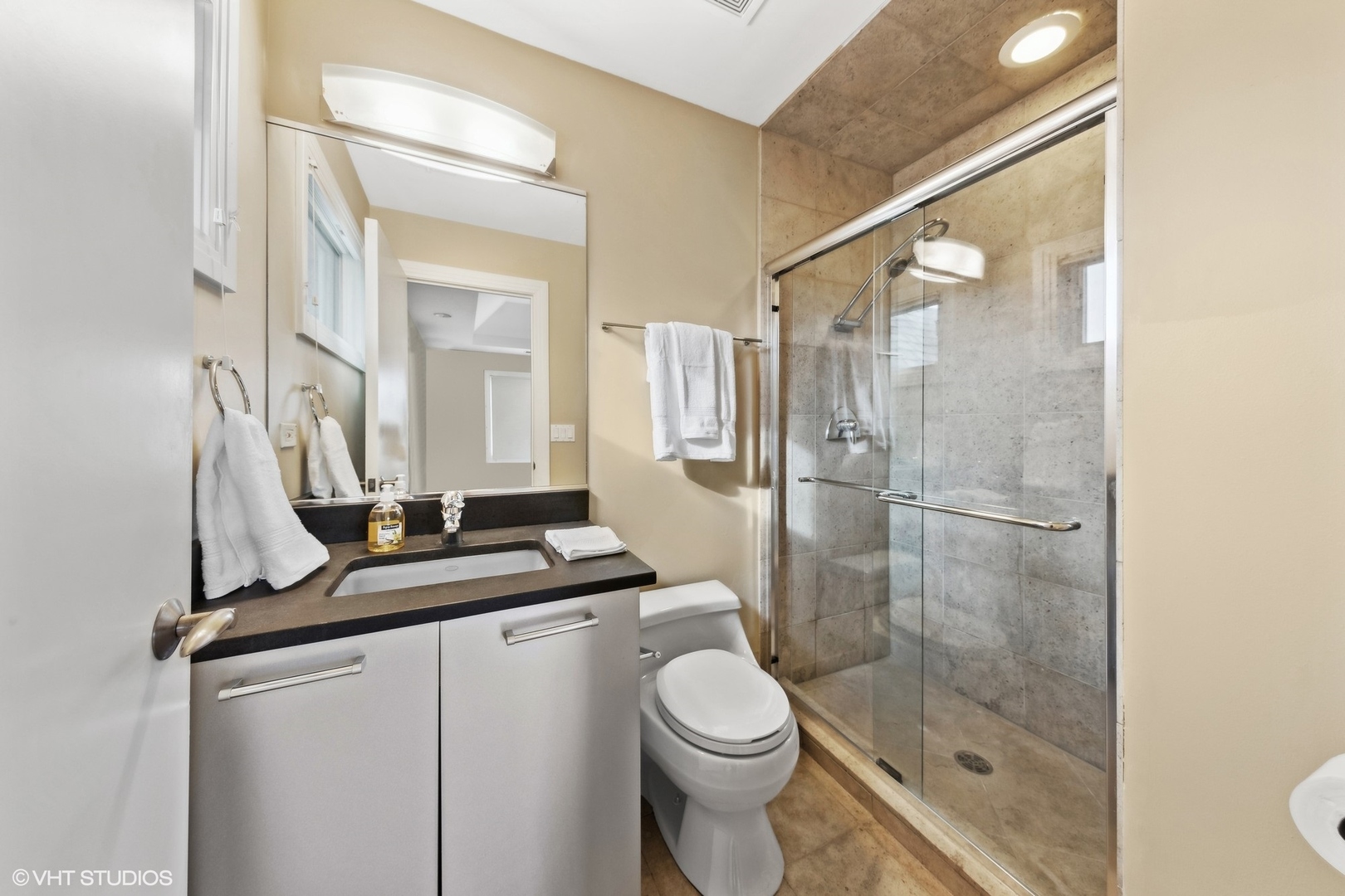 6885 Fieldstone Drive Burr Ridge, IL 60527 - Photo 21 of 37 a bathroom with a granite countertop sink toilet a mirror and shower