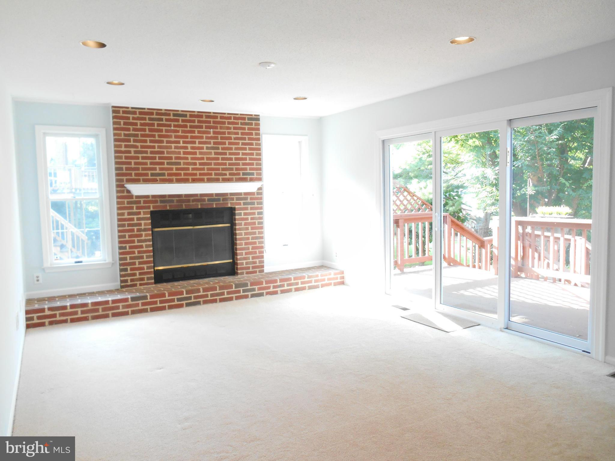 211 Hunters Ridge Road Lutherville-Timonium, MD 21093 - Photo 9 of 27 Family Room with fireplace and sliders to deck