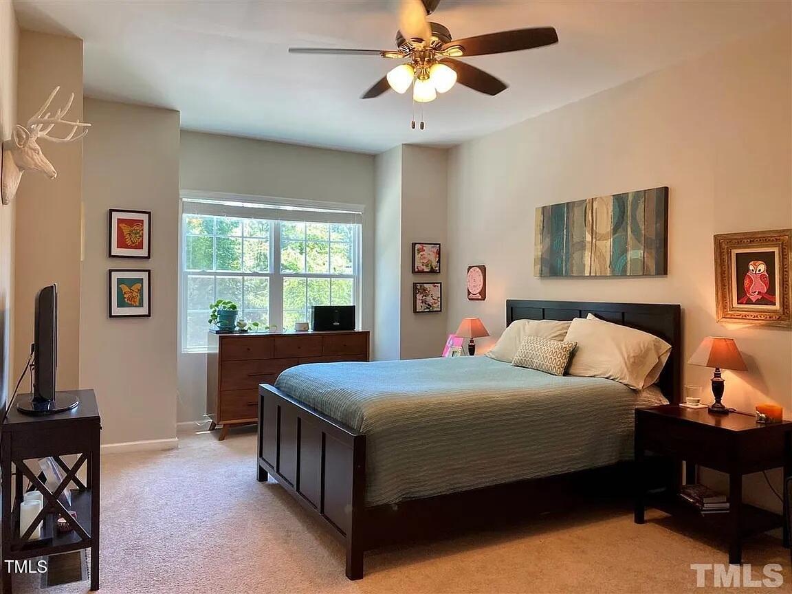 1106 Nicklaus Drive Durham, NC 27705 - Photo 3 of 7 a bedroom with a bed a dresser next to a window