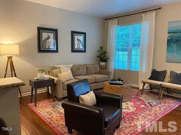 1106 Nicklaus Drive Durham, NC 27705 - Photo 4 of 7 a living room with furniture and a rug