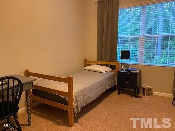 1106 Nicklaus Drive Durham, NC 27705 - Photo 6 of 7 a bedroom with a bed chair and a desk