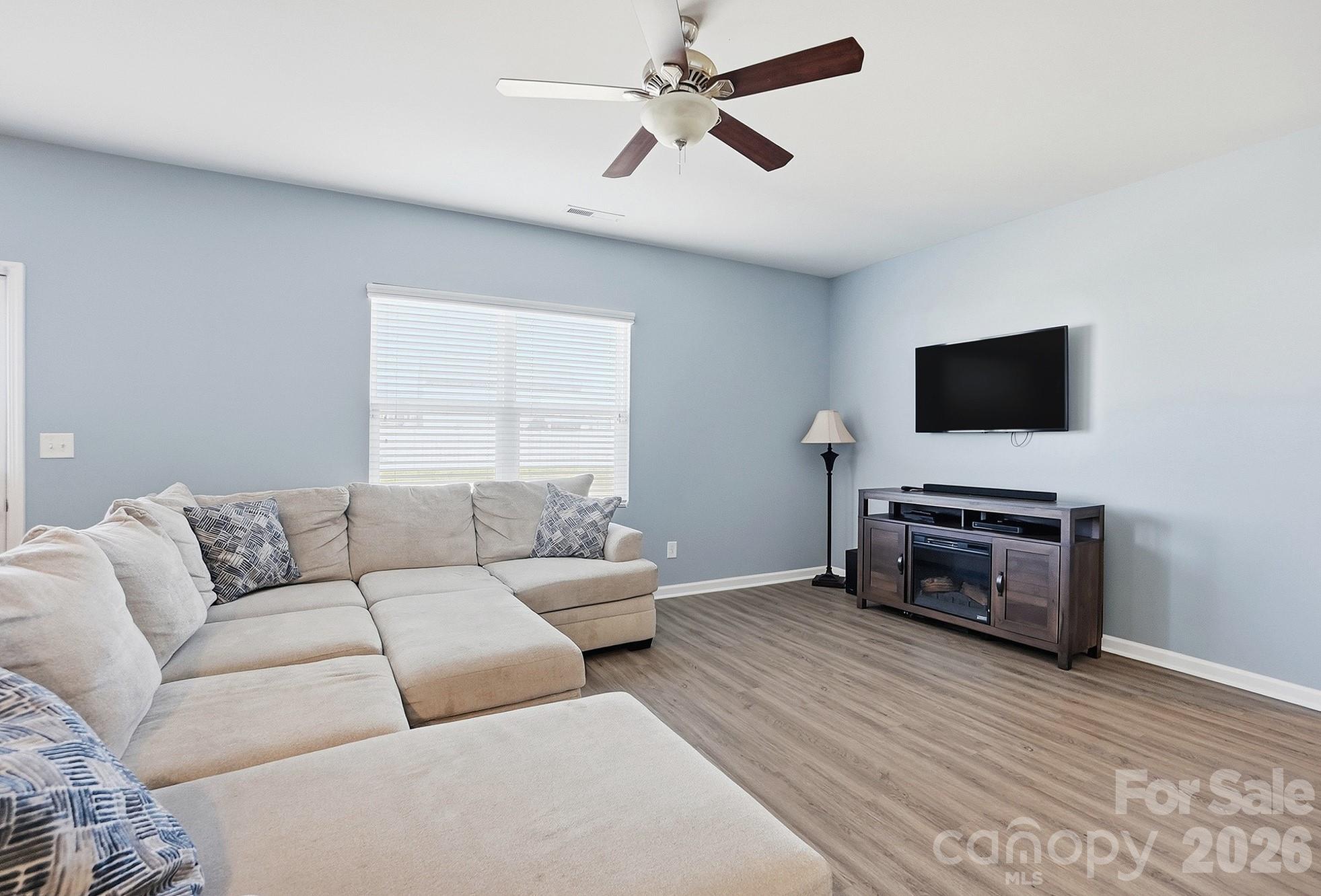 2009 Houndscroft Road Indian Trail, NC 28079 - Photo 7 of 25 a living room with furniture and a flat screen tv