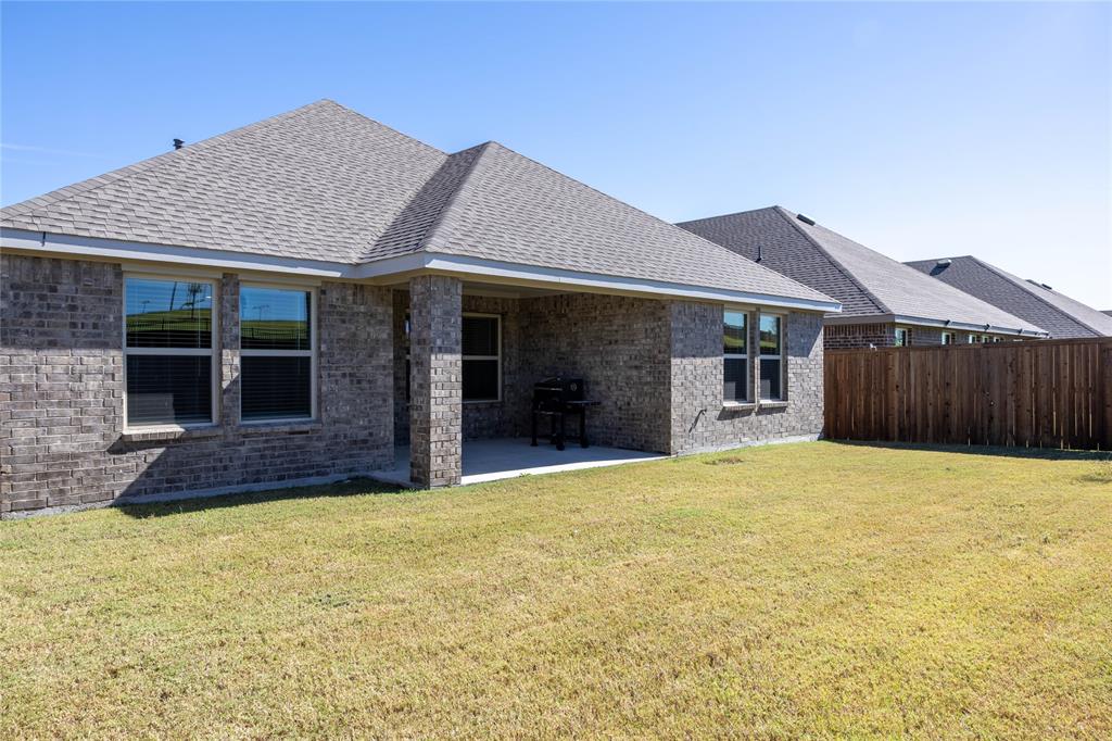 419 Revolution Road Fate, TX 75189 - Photo 11 of 19 Back of property with a patio, brick siding, and a shingled roof