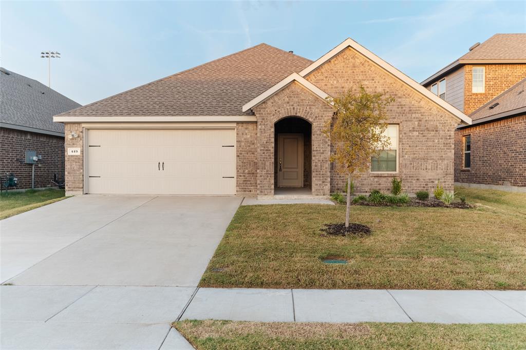 419 Revolution Road Fate, TX 75189 - Photo 2 of 19 View of front of home with a front yard, roof with shingles, brick siding, and concrete driveway