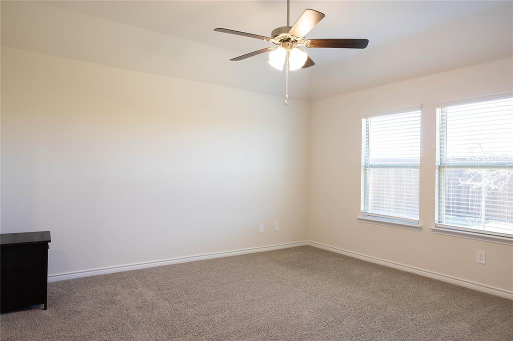 419 Revolution Road Fate, TX 75189 - Photo 7 of 19 Carpeted empty room with baseboards and a ceiling fan
