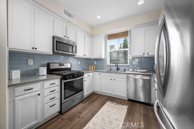 46 Hinterland Way Ladera Ranch, CA 92694 - Photo 11 of 46 a kitchen with stainless steel appliances white cabinets and a sink