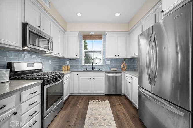 46 Hinterland Way Ladera Ranch, CA 92694 - Photo 12 of 46 a kitchen with stainless steel appliances granite countertop a refrigerator sink and stove