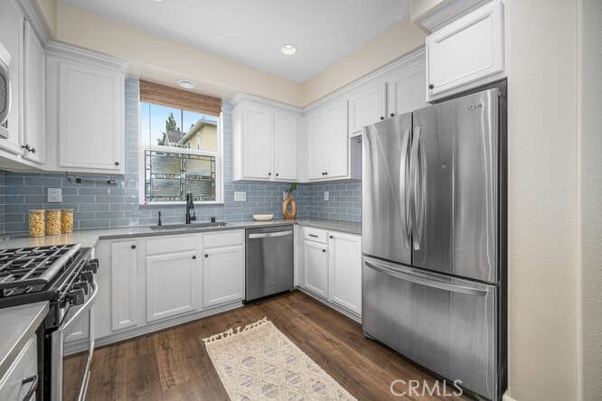 46 Hinterland Way Ladera Ranch, CA 92694 - Photo 13 of 46 a kitchen with a refrigerator a sink and a stove