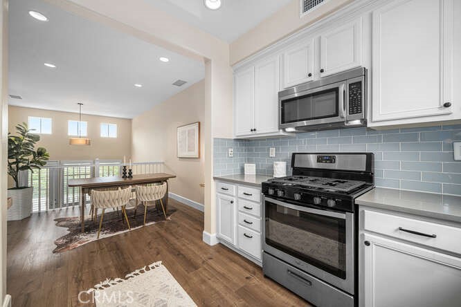 46 Hinterland Way Ladera Ranch, CA 92694 - Photo 15 of 46 a kitchen with stainless steel appliances white cabinets and a stove top oven