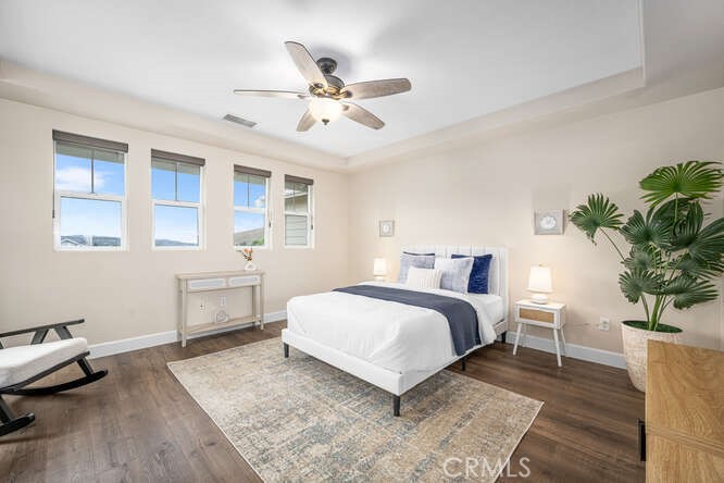 46 Hinterland Way Ladera Ranch, CA 92694 - Photo 22 of 46 a spacious bedroom that has a bed and a table in it