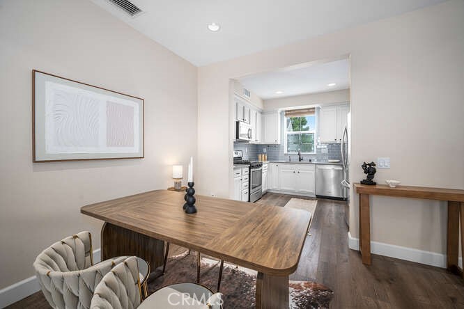46 Hinterland Way Ladera Ranch, CA 92694 - Photo 10 of 46 a kitchen with a table chairs refrigerator and microwave